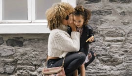 A mom holder her daughter, which represents the need for life insurance, as discussed in this Ethos Life Insurance Review.