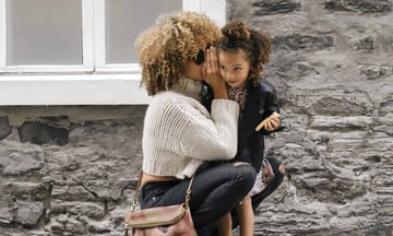 A mom holder her daughter, which represents the need for life insurance, as discussed in this Ethos Life Insurance Review.