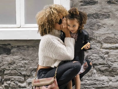 A mom holder her daughter, which represents the need for life insurance, as discussed in this Ethos Life Insurance Review.