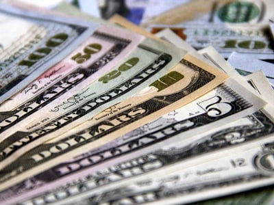 A close-up, fanned-out display of various U.S. dollar denominations, including one hundred, fifty, twenty, ten, and five-dollar bills, creates a compelling visual that immediately draws attention to the article's focus on personal finance and budgeting. The crisp, green and beige currency notes are neatly arranged, suggesting financial organization and the careful management of money, which directly ties into the purpose of the YNAB (You Need A Budget) app discussed in the article. This image reinforces the importance of understanding and allocating every dollar, a core principle of effective budgeting and a key benefit highlighted in the review of YNAB as a budgeting software tool. The prominent display of different denominations emphasizes the practical application of budgeting for various expenses and financial goals.