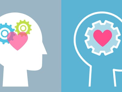 This image features a vibrant, segmented background in shades of blue and white, serving as a header for an article about mental health resources. Prominently displayed in bold, red and white text at the top, it reads "FREE OR LOW-COST MENTAL HEALTH RESOURCES FOR STUDENTS & RECENT GRADS," directly addressing the article's focus on supporting those burdened by student loan debt. The lower portion of the image shows two circular icons with gears, one with pink and green gears on a white background, and another with white gears and a pink heart on a blue background, symbolizing the mechanisms and care involved in mental health support. These visual elements reinforce the article's theme of providing accessible help for students and recent graduates navigating the stresses of college and post-graduation life, particularly concerning the financial strain of student loans and its impact on mental well-being.
