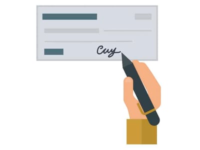 A simple, flat graphic illustration depicts a hand holding a dark grey pen, poised as if signing a light grey check. The hand, stylized with light brown skin and a brown sleeve, is positioned on the lower right, with the pen tip near a cursive signature on the check. The check itself has placeholder lines for the date, payee, amount, and bank information, common elements of a financial instrument. The overall impression is one of a transaction or payment being authorized. This image contextually relates to the accompanying article discussing the 2020 Covid-19 stimulus checks, the CARES Act, and the financial assistance provided to Americans during the coronavirus pandemic, illustrating the concept of receiving and signing a payment.