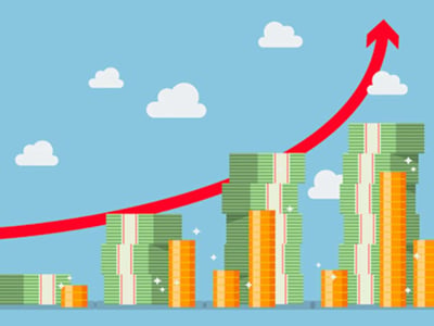 A colorful cartoon illustration depicts financial growth and successful retirement planning, relevant to the Boldin review for financial independence. Against a light blue sky with several white, fluffy clouds, stacks of green paper money and golden coin rolls are arranged in an increasing bar graph pattern from left to right, symbolizing growing savings and investments. A prominent red arrow curves upwards over these financial stacks, pointing towards the top right corner, emphasizing an upward trend in wealth and the maximization of one's estate. In the bottom left corner, the white text "THE COLLEGE INVESTOR" is displayed, indicating the source of this article and its focus on helping individuals, including college investors, build their path to retirement savings goals. The image visually represents the positive outcomes of using tools like NewRetirement for detailed charting and reports on financial planning.