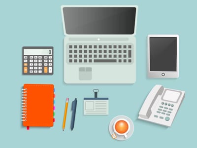 This flat-lay image displays essential tools for an individual investor, arranged neatly on a light blue background. At the top center, a silver laptop with a dark screen and white keyboard signifies detailed analysis and research. To its left, a dark calculator with an orange display highlights financial computations, while to its right, a silver tablet with a dark screen suggests mobile access to investment platforms. Below the laptop, an orange spiral-bound notebook and a yellow pencil with a black pen emphasize note-taking and planning. A white ID badge with a blue clip rests beside the writing tools, possibly indicating professional investment activities. In the bottom right, a light grey landline phone represents communication, and next to it, a white cup of coffee or tea suggests extended periods of work. The phrase "THE COLLEGE INVESTOR" is prominently displayed in white text in the bottom left corner, reinforcing the article's focus on helping college investors utilize services like Morningstar Investor for stock, ETF, and mutual fund analysis.