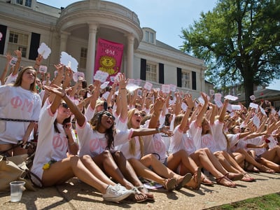 The University of Alabama Phi Mu's newest sorority members, in front, gather at sorority house for a photograph during Bid Day on Saturday, Aug. 16, 2014, in Tuscaloosa, Ala. The university became embroiled in controversy in 2013 after the student newspaper reported some white sororities had rejected blacks as new members because of race. At the end of 2014 sorority recruitment, black women made up 1 percent of new members. (AP Photo/Brynn Anderson)