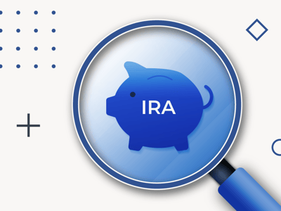 This image features a large magnifying glass prominently displaying a dark blue piggy bank icon with the white text "IRA" centered on its side, symbolizing a focus on Individual Retirement Accounts and alternative investments. The magnifying glass itself has a silver rim and a dark blue handle, indicating a thorough review of financial options. The background is a light blue and white abstract design with a dark blue semi-oval shape in the top left corner containing white text that reads "THE COLLEGE INVESTOR," reinforcing the article's target audience and financial education theme. Additional graphic elements include a black plus sign, several small black dots, and a hollow dark blue circle, adding a modern, clean aesthetic. This visual reinforces the article's detailed review of IRA Financial as a self-directed IRA manager offering diverse retirement plans beyond traditional stocks and bonds.