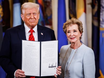 President Donald Trump holds the executive order to dismantle the Department of Education he just signed with Education Secretary Linda McMahon during an event in the East Room of the White House in Washington, D.C. on March 20, 2025. The Department of Education was first formed in 1980 by President Jimmy Carter and has long been a target for Republicans. (Photo by Samuel Corum/Sipa USA)(Sipa via AP Images)