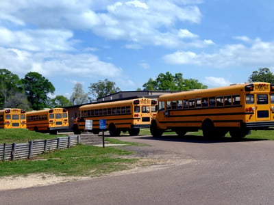 Buses lineup to transport students back home at end of school day. Four buses with some students already loaded. Photo: Cheshier1021