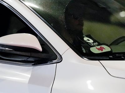Uber and Lyft stickers are seen on a ride share vehicle is seen at the Nashville International Airport, Friday, Aug. 30, 2024, in Nashville, Tenn. (AP Photo/George Walker IV)