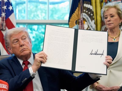 President Donald Trump holds a signed an executive order relating to school discipline policies as Education Secretary Linda McMahon listens in the Oval Office of the White House, Wednesday, April 23, 2025, in Washington. (AP Photo/Alex Brandon)