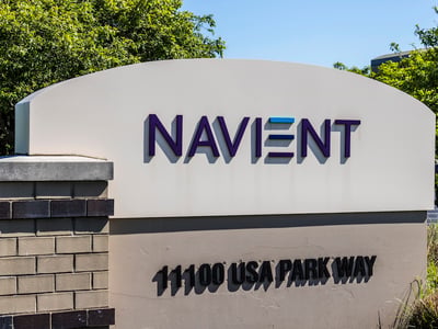 Outdoor sign for the Navient corporate headquarters, featuring the company logo with purple and blue letters on a white background. This image provides visual context for the article discussing the rollout of compensation checks to borrowers following the 2024 settlement between the CFPB and Navient over alleged servicing misconduct. Source: The College Investor