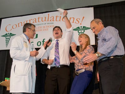 Matthew Stark, center, celebrates with his mother Barbara, second from right, father Steven, right, of Boca Raton, Fla., and Pascal J. Goldschmidt, left, dean for the University of Miami Miller School of Medicine, after learning which residency training program he was matched with, Friday, March 18, 2016, in Miami. Stark was one of 186 medical students at the school that learned where their studies would lead them next during Match Day, a day considered to be the crucial first step to practicing medicine, is an event held simultaneously at every medical school in the U.S. (AP Photo/Wilfredo Lee)