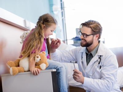 A doctor and young patient illustrating the 2027 HSA contribution limits were release. Source: The College Investor