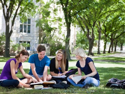 College students on campus, reflecting the latest trend of capping tuition at a percentage of AGI.