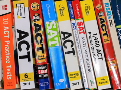 Row of ACT and SAT books contain standardized practice tests for university admissions in USA.