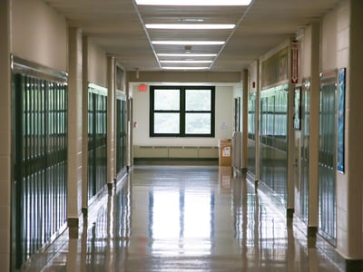 High school hallway representing high school guidance counselor push to college.