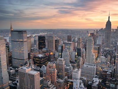 New York City skyline aerial view at sunset with colorful cloud and skyscrapers of midtown Manhattan.