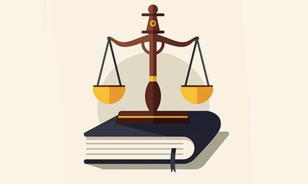 A close-up, graphic image features a dark brown wooden judge's gavel resting on a matching block on the right, with a vintage-style gold scale of justice balancing on the left. The scale's left pan is filled with gold, symbolizing the significant financial burden of student loan debt for lawyers, which can average $180,000 for law school graduates. The background shows blurred text, partially revealing "STUDENT LOAN FORGIVENESS FOR LAWYERS," with "LAWYERS" highlighted in red. This visual directly supports the article's focus on various student loan forgiveness programs available to practicing lawyers and addresses the challenges of high six-figure debt despite potentially lucrative careers.
