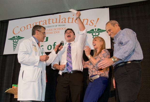 Matthew Stark, center, celebrates with his mother Barbara, second from right, father Steven, right, of Boca Raton, Fla., and Pascal J. Goldschmidt, left, dean for the University of Miami Miller School of Medicine, after learning which residency training program he was matched with, Friday, March 18, 2016, in Miami. Stark was one of 186 medical students at the school that learned where their studies would lead them next during Match Day, a day considered to be the crucial first step to practicing medicine, is an event held simultaneously at every medical school in the U.S. (AP Photo/Wilfredo Lee)