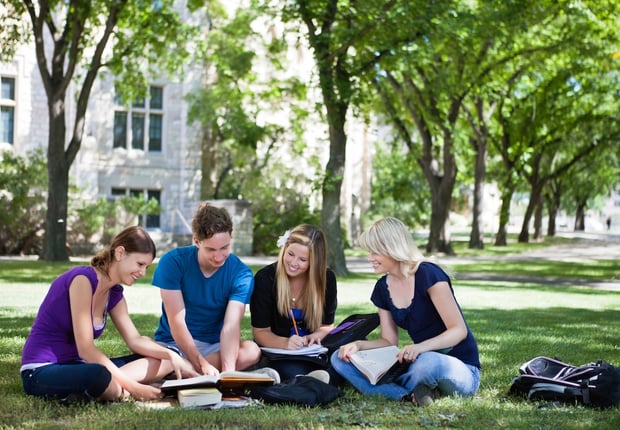 College students on campus, reflecting the latest trend of capping tuition at a percentage of AGI.