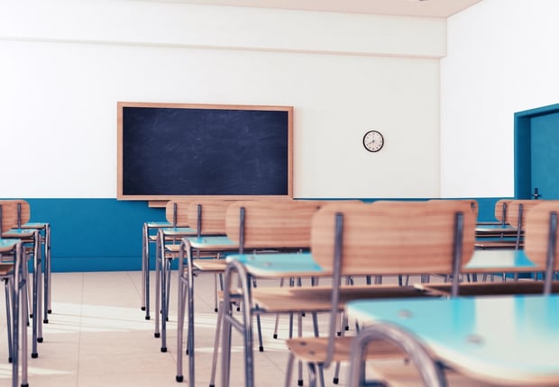 Empty school classroom with desks and chairs