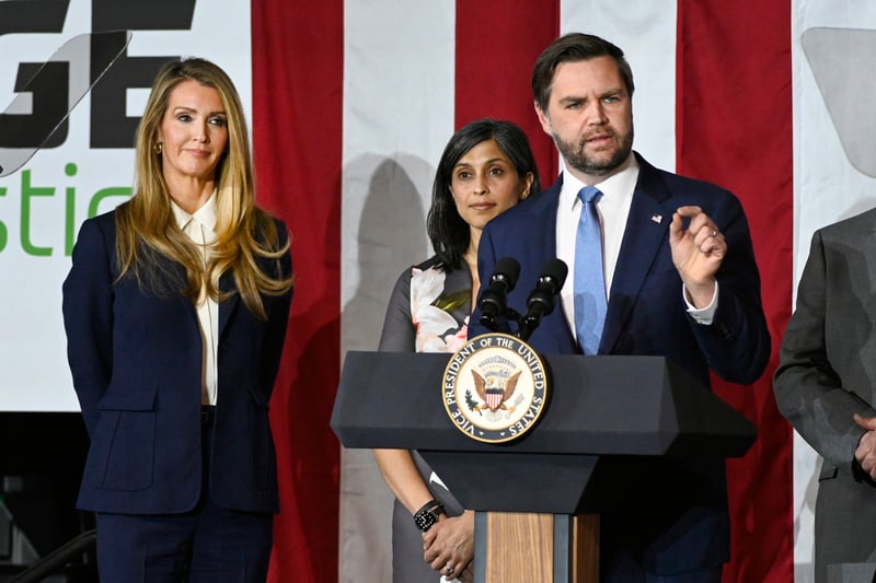 Vance Vice President JD Vance, right, speaks at a rally about "America's industrial resurgence," as he is flanked by Administrator of the Small Business Administration Kelly Loeffler, far left, and his wife, Usha Vance, Friday, March 14, 2025, at Vantage Plastics in Bay City, Mich. (AP Photo/Jose Juarez)