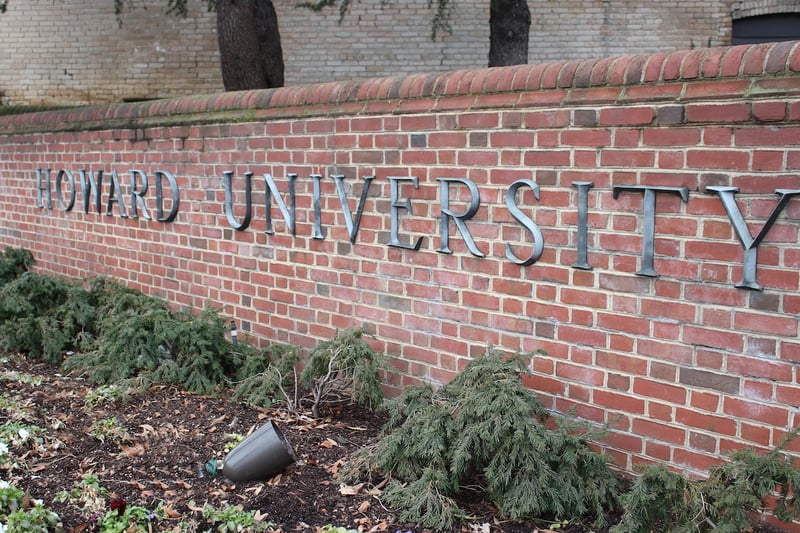 Howard University Exterior view of the Howard University sign on a brick wall.