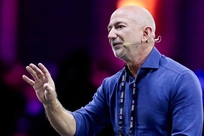 Amazon founder Jeff Bezos gestures as he speaks at the main panel of Italian Tech Week 2025 in Turin, Italy October 3, 2025. REUTERS/Remo Casilli