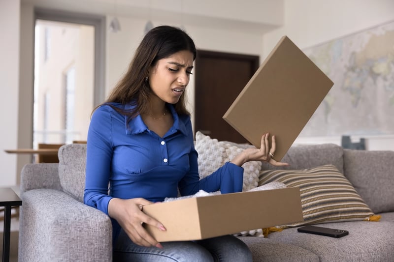 College Pricing Black Box Upset young woman opening box, an analogy to the disgust families face in dealing with the college pricing black box. Source: The College Investor