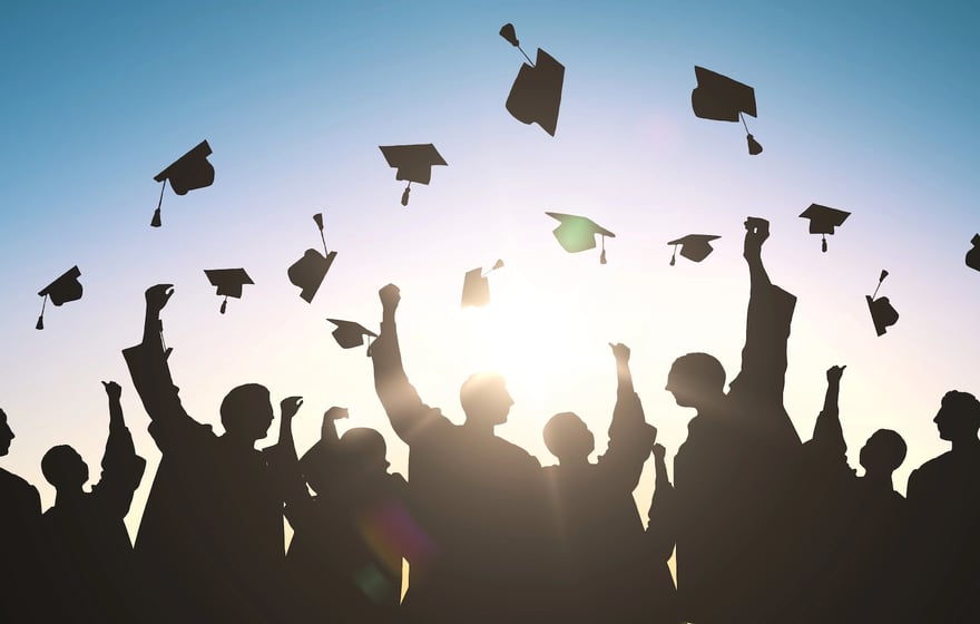 College grads tossing caps in the air | Photo Credit Syda_Productions