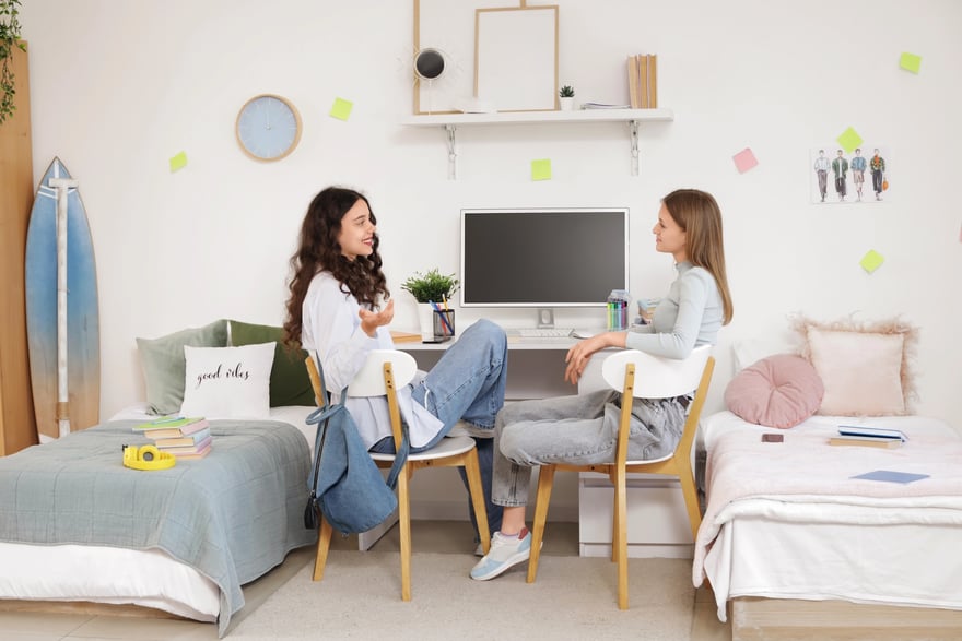 Depositphotos_750006966_XL Female students talking at table in dorm room | Photo Credit: zereznly