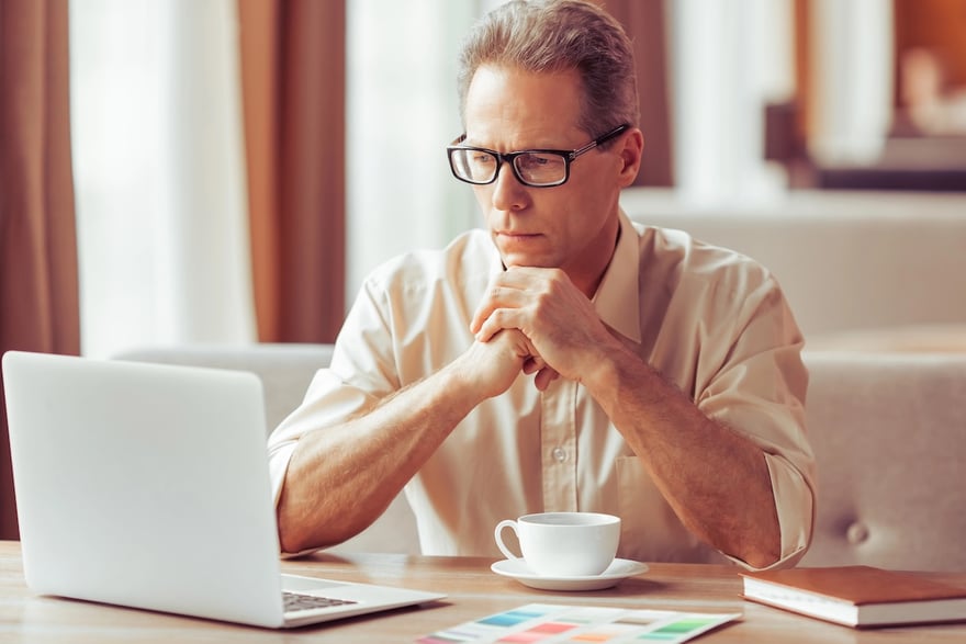 Parent PLUS Loan borrower at computer | Source: The College Investor