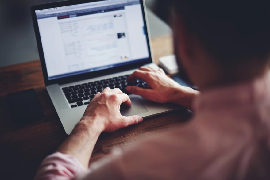 Cropped image of a college student working on a laptop.  Source: The College Investor