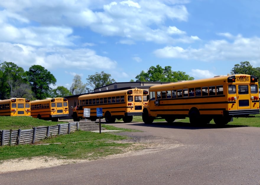 Awaiting End of School Buses lineup to transport students back home at end of school day. Four buses with some students already loaded. Photo: Cheshier1021