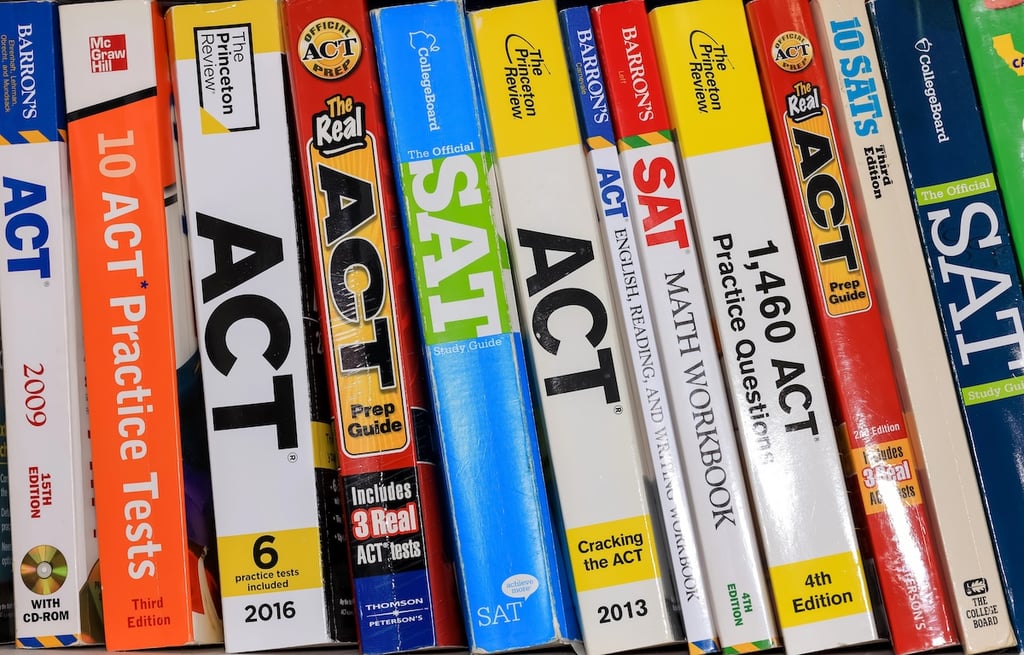 Row of ACT and SAT books contain standardized practice tests for university admissions in USA.