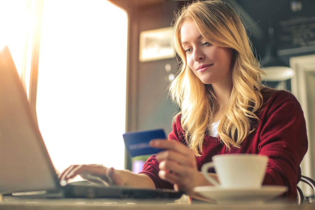 A woman looking at building her credit on a laptop.