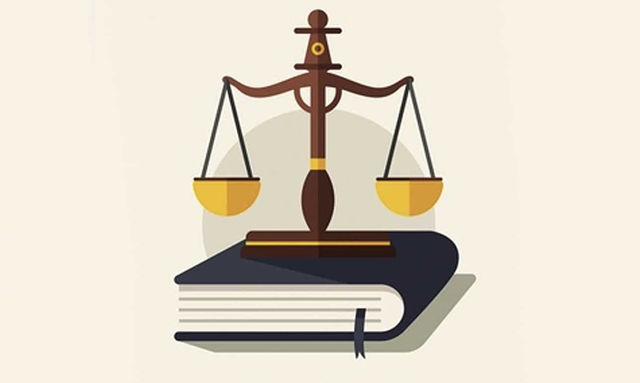 Wooden judge's gavel beside a gold scale of justice, representing student loan forgiveness programs for lawyers