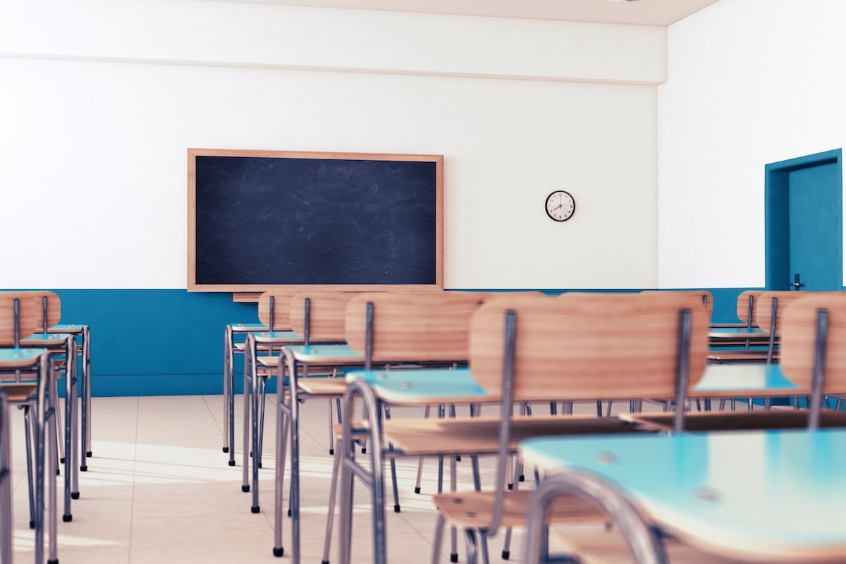 Empty school classroom with desks and chairs